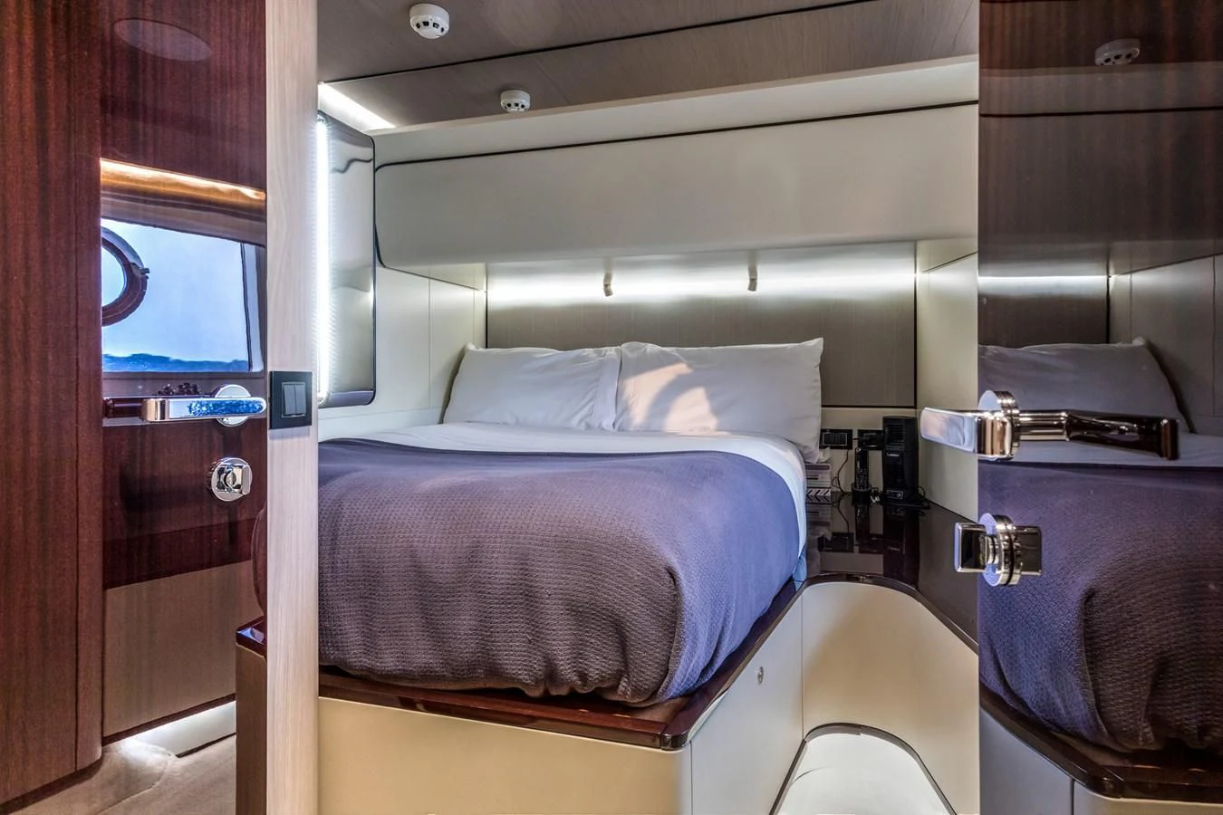 a bed with a purple blanket aboard CAPTAIN MORGAN II Yacht for Sale