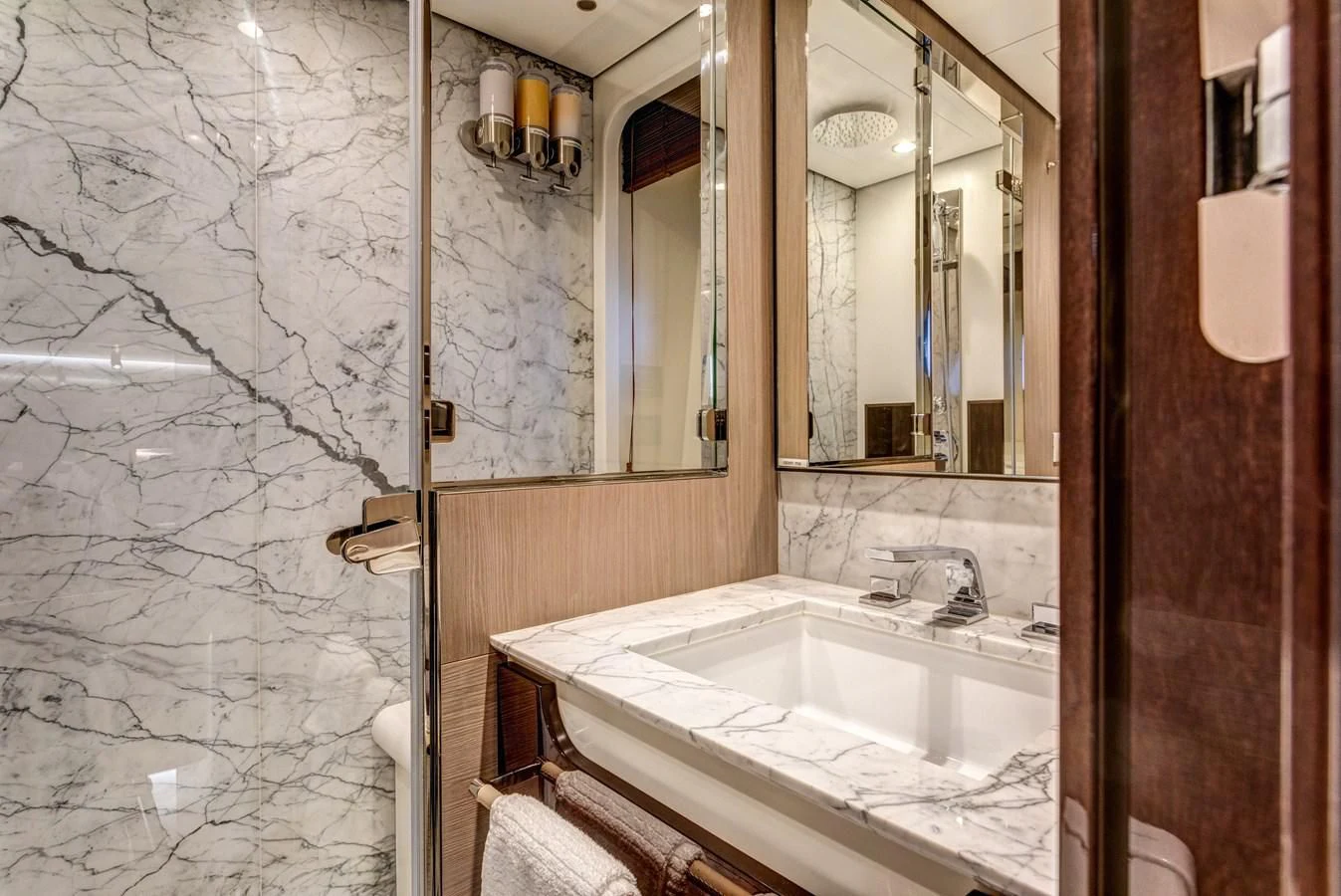 a bathroom with a sink and mirror aboard CAPTAIN MORGAN II Yacht for Sale