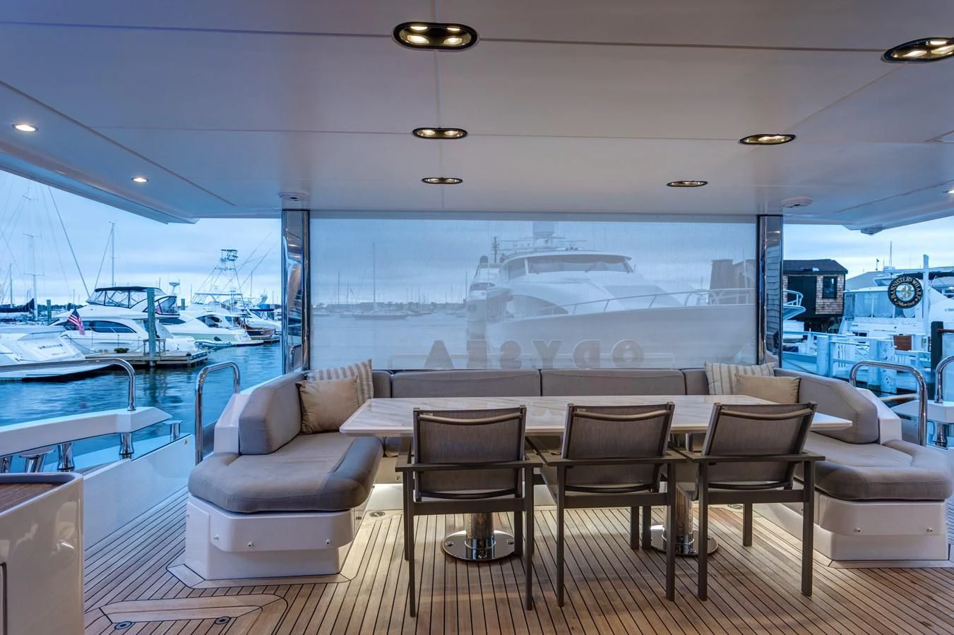 a room with a table chairs and a view of the water aboard CAPTAIN MORGAN II Yacht for Sale