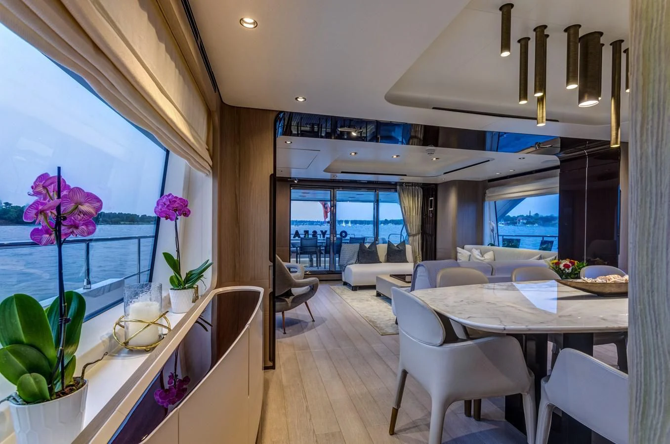 a room with a table chairs and plants aboard CAPTAIN MORGAN II Yacht for Sale