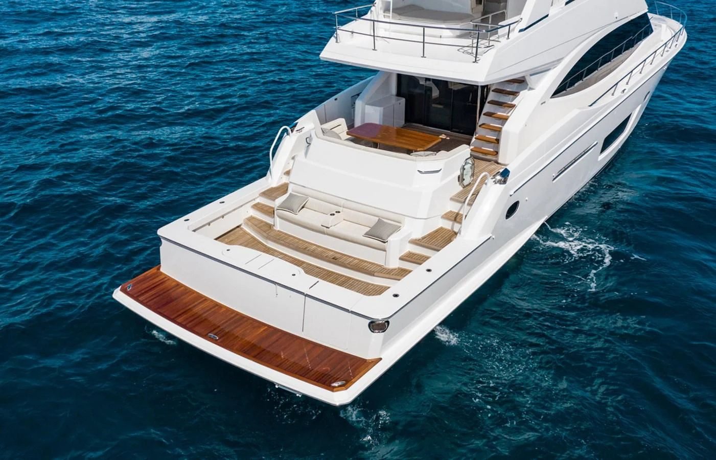 a white boat on the water aboard NEW VIKING 82 COCKPIT MOTOR YACHT Yacht for Sale