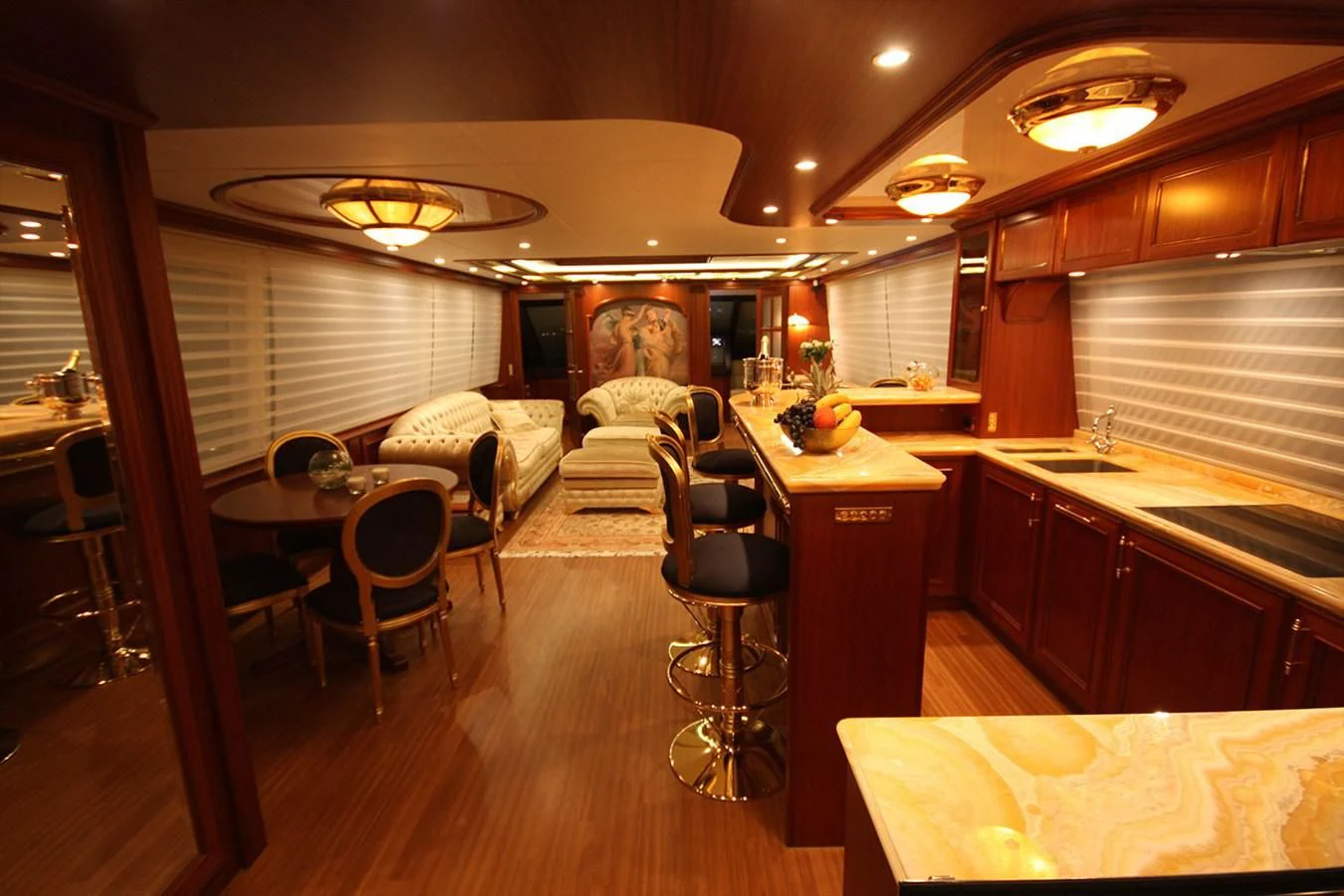 a kitchen with a dining table and chairs aboard ORION Yacht for Sale