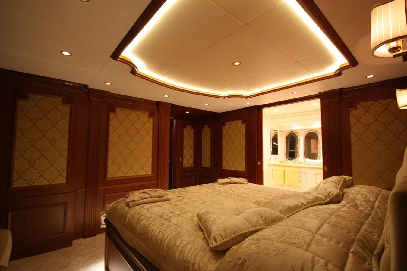 a bedroom with a bed and a wood door aboard ORION Yacht for Sale