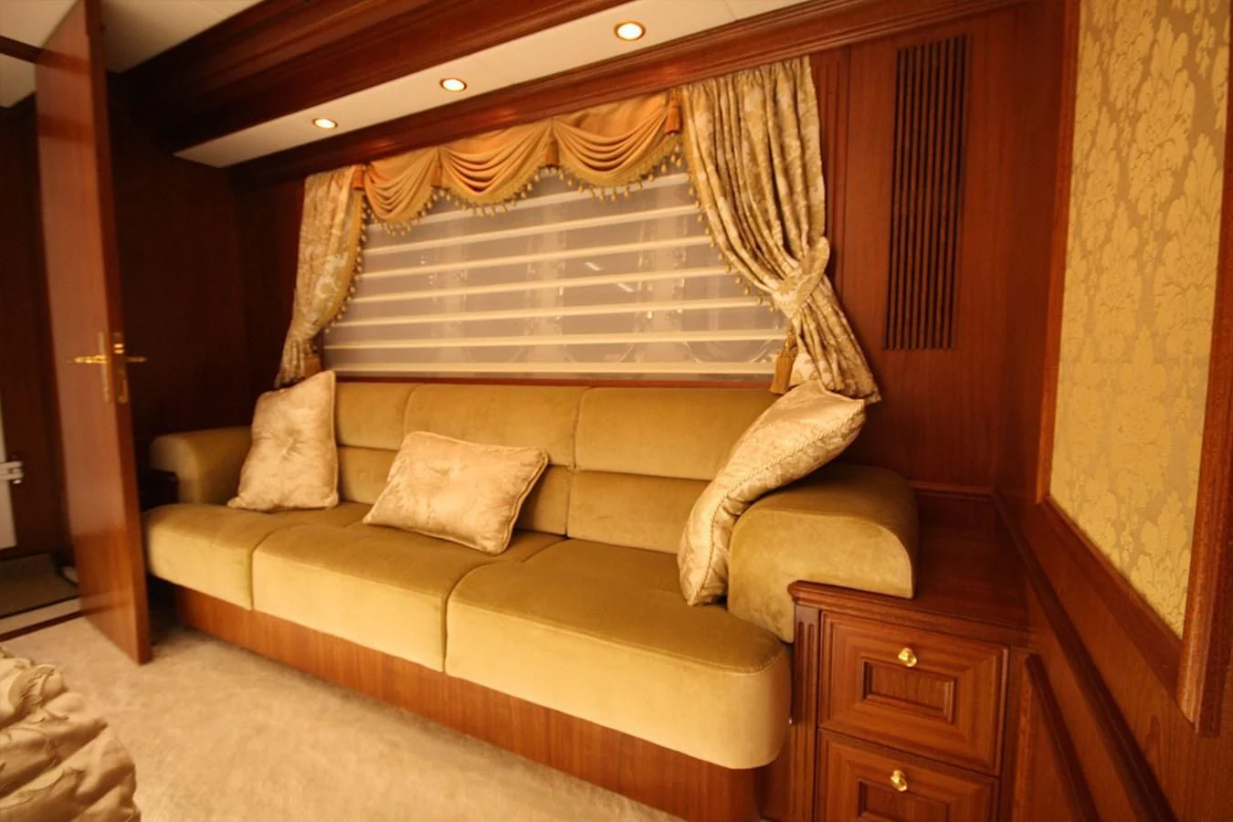 a couch with a wood headboard aboard ORION Yacht for Sale