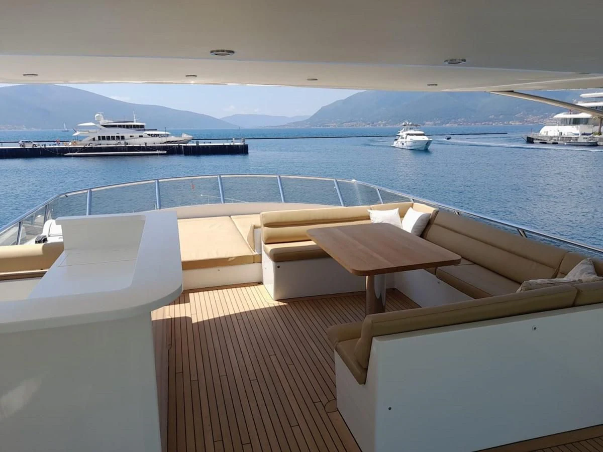 a deck with chairs and boats in the water aboard ORION Yacht for Sale