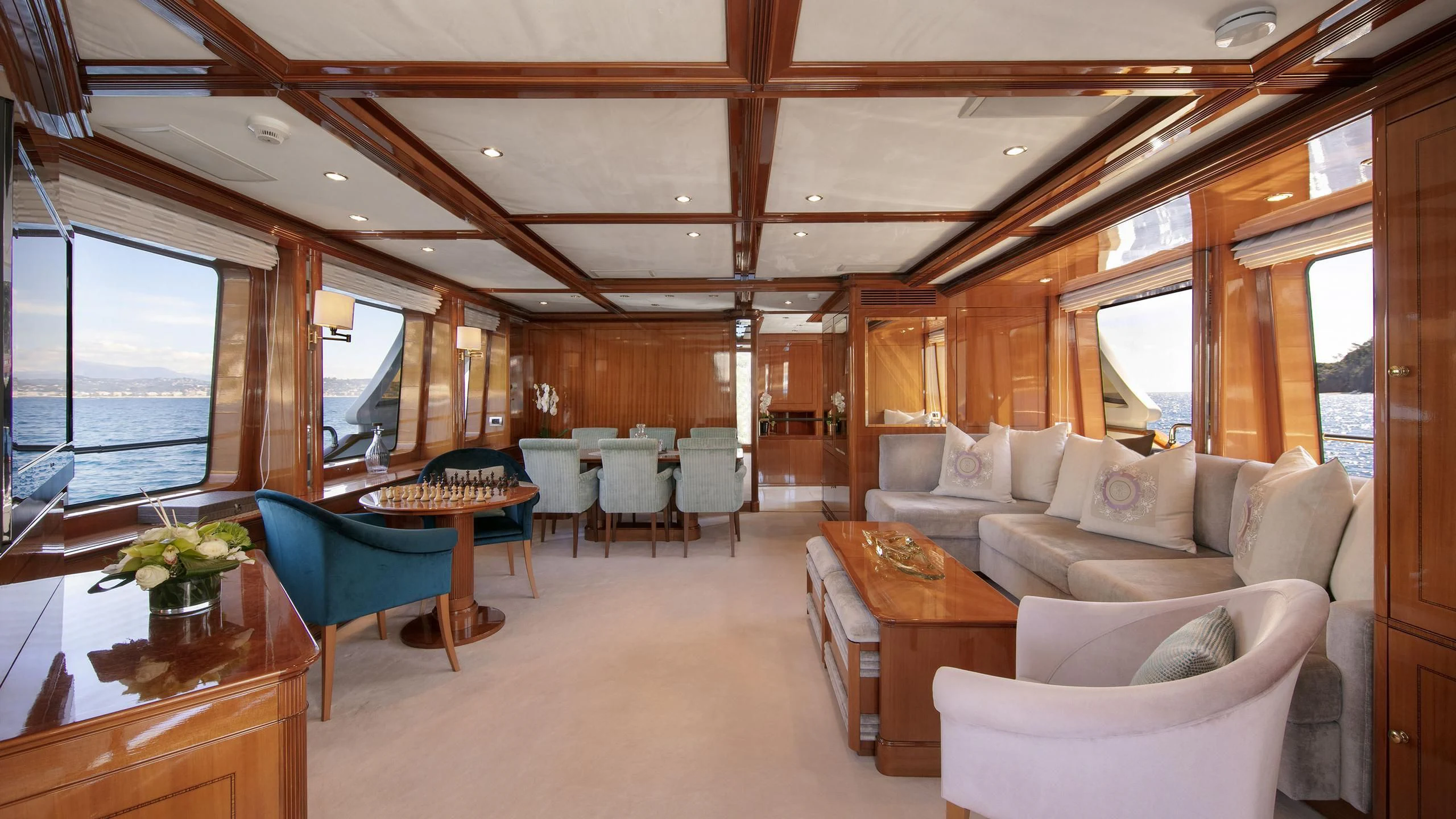 a living room with a table and chairs aboard FARFALLINA Yacht for Sale