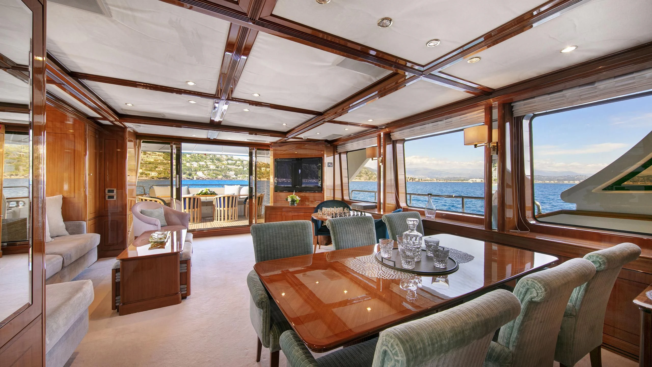a living room with a large window aboard FARFALLINA Yacht for Sale