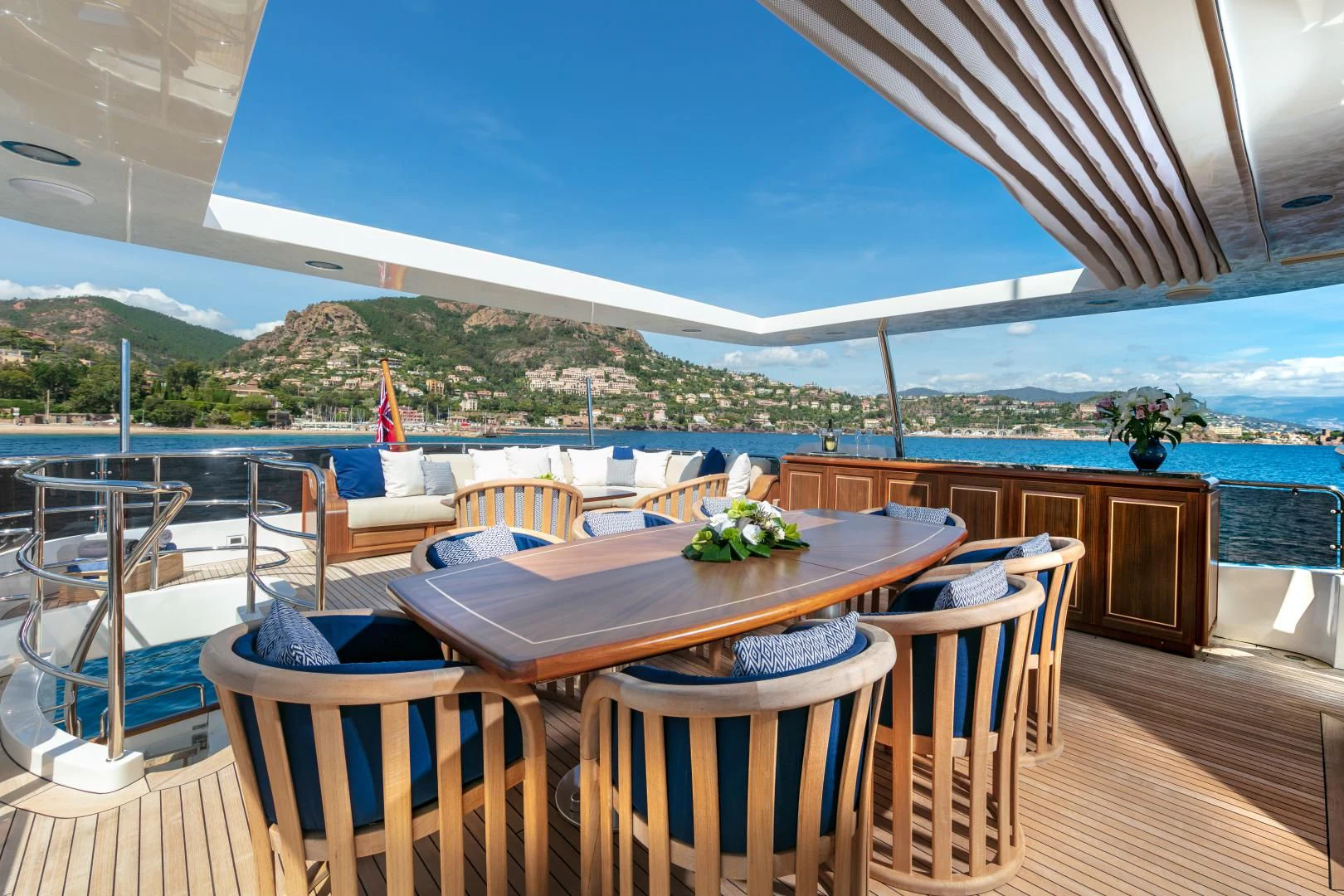 a table on a deck overlooking a body of water aboard FARFALLINA Yacht for Sale