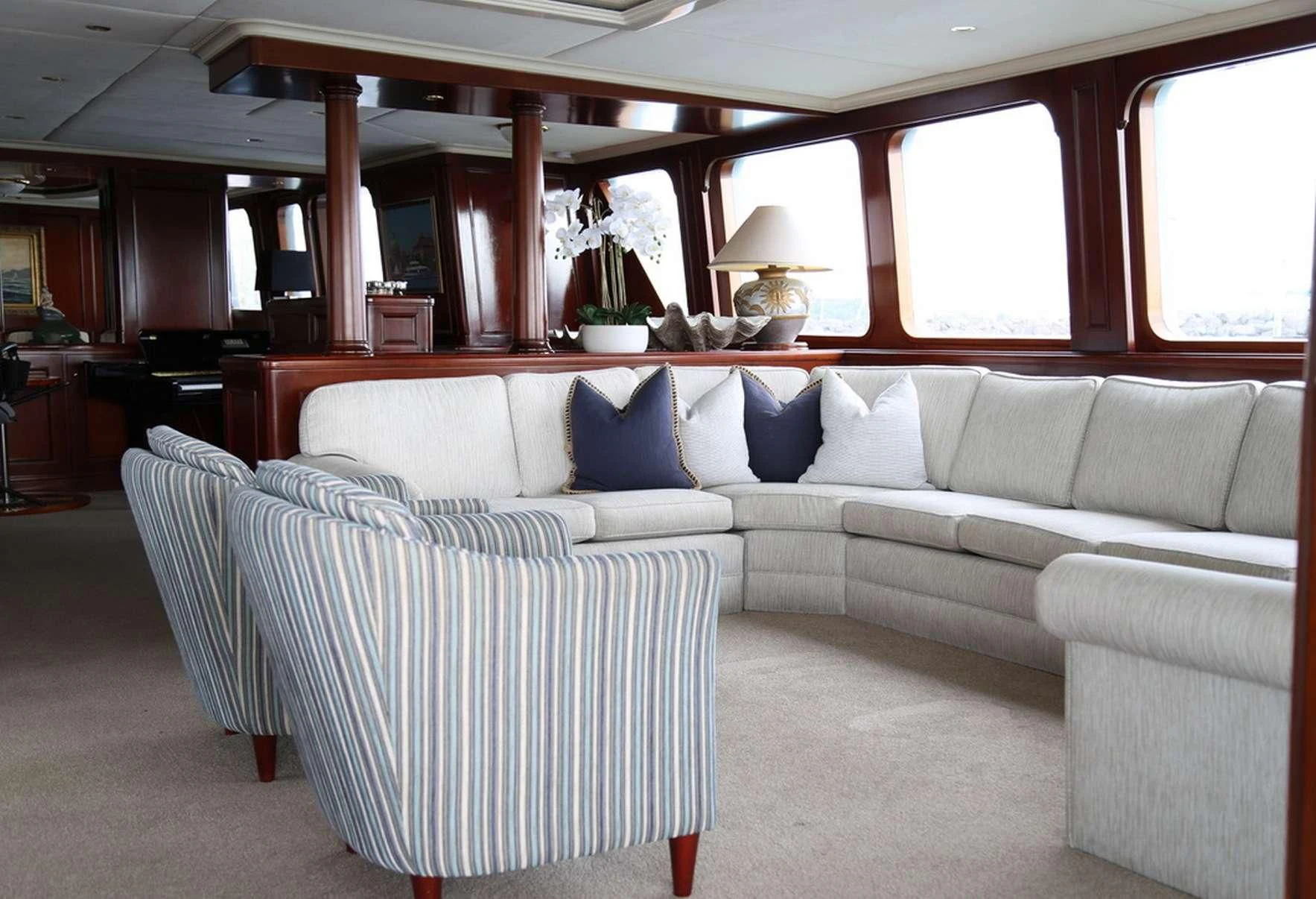 a couch and a chair in a room aboard PACIFIC MERMAID Yacht for Sale