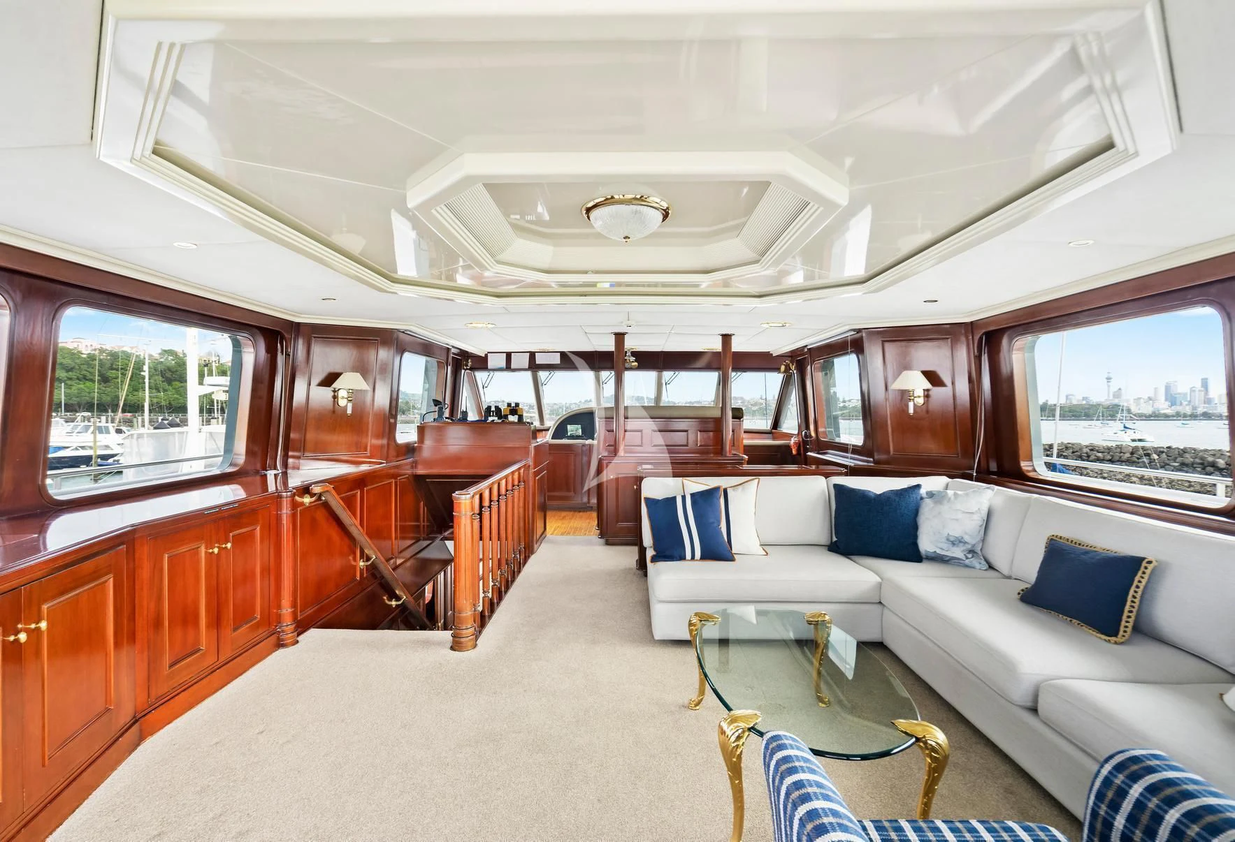 a large room with a couch and a window aboard PACIFIC MERMAID Yacht for Sale