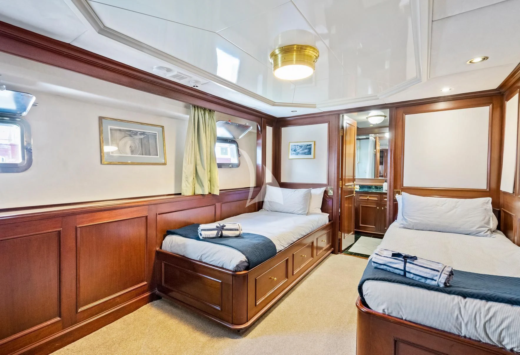 a room with a bed and a mirror aboard PACIFIC MERMAID Yacht for Sale