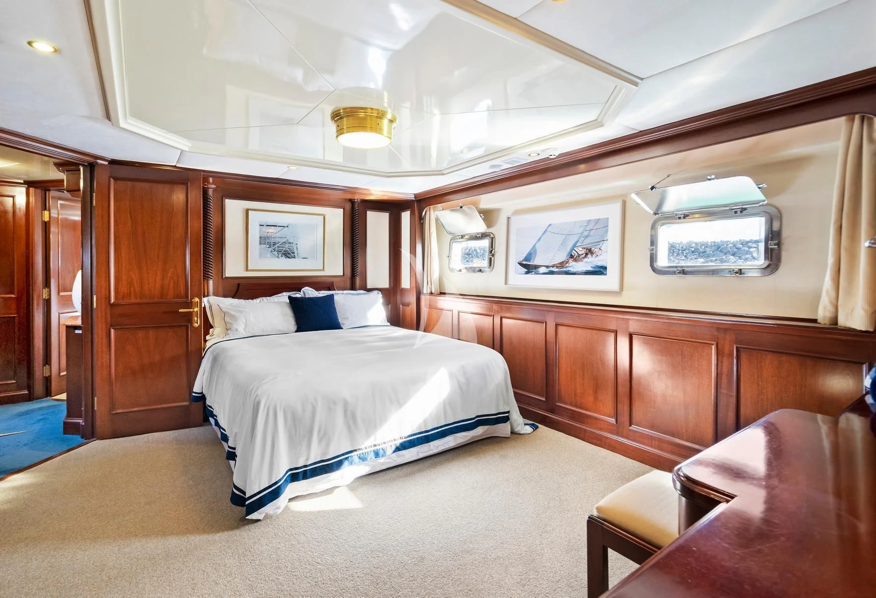 a room with a bed and a television aboard PACIFIC MERMAID Yacht for Sale