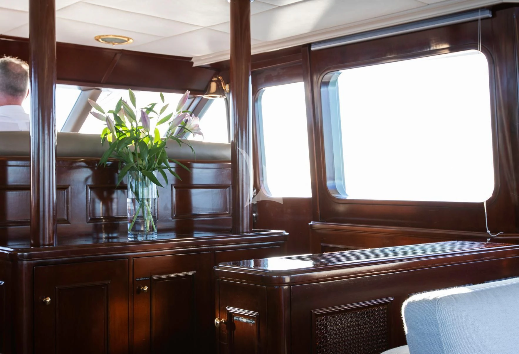 a vase of flowers on a table aboard PACIFIC MERMAID Yacht for Sale