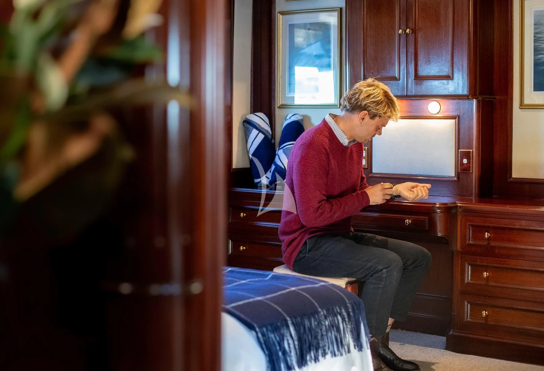 a man sitting in a chair aboard PACIFIC MERMAID Yacht for Sale