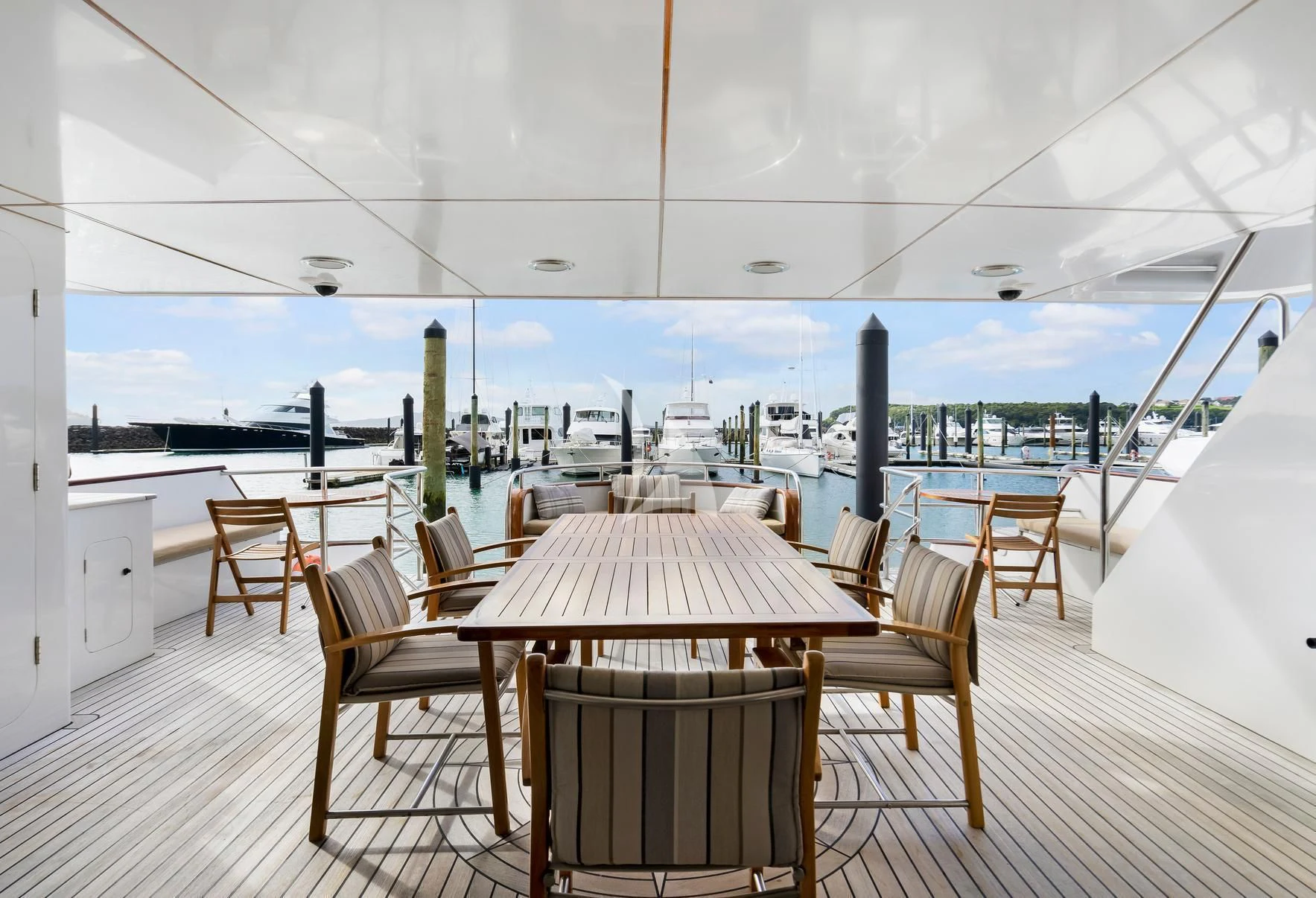 a table and chairs on a deck aboard PACIFIC MERMAID Yacht for Sale