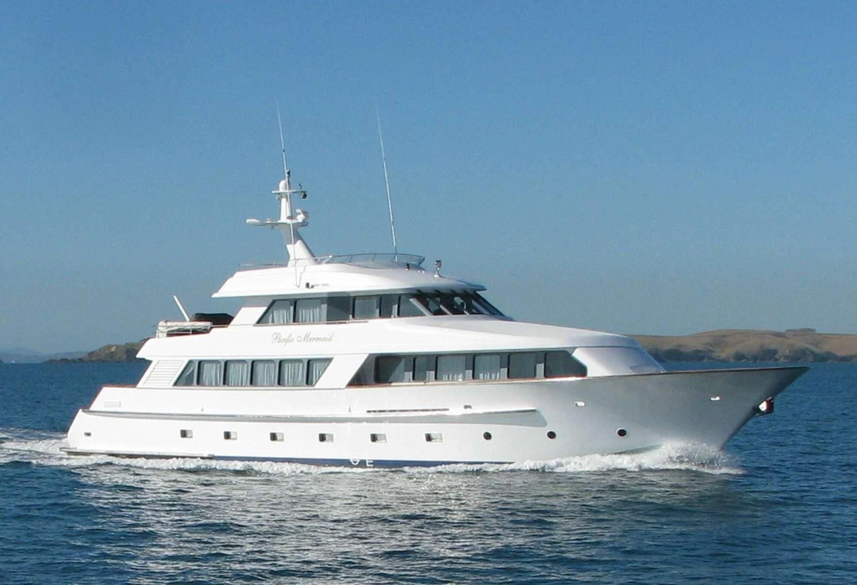 a white yacht in the water aboard PACIFIC MERMAID Yacht for Sale