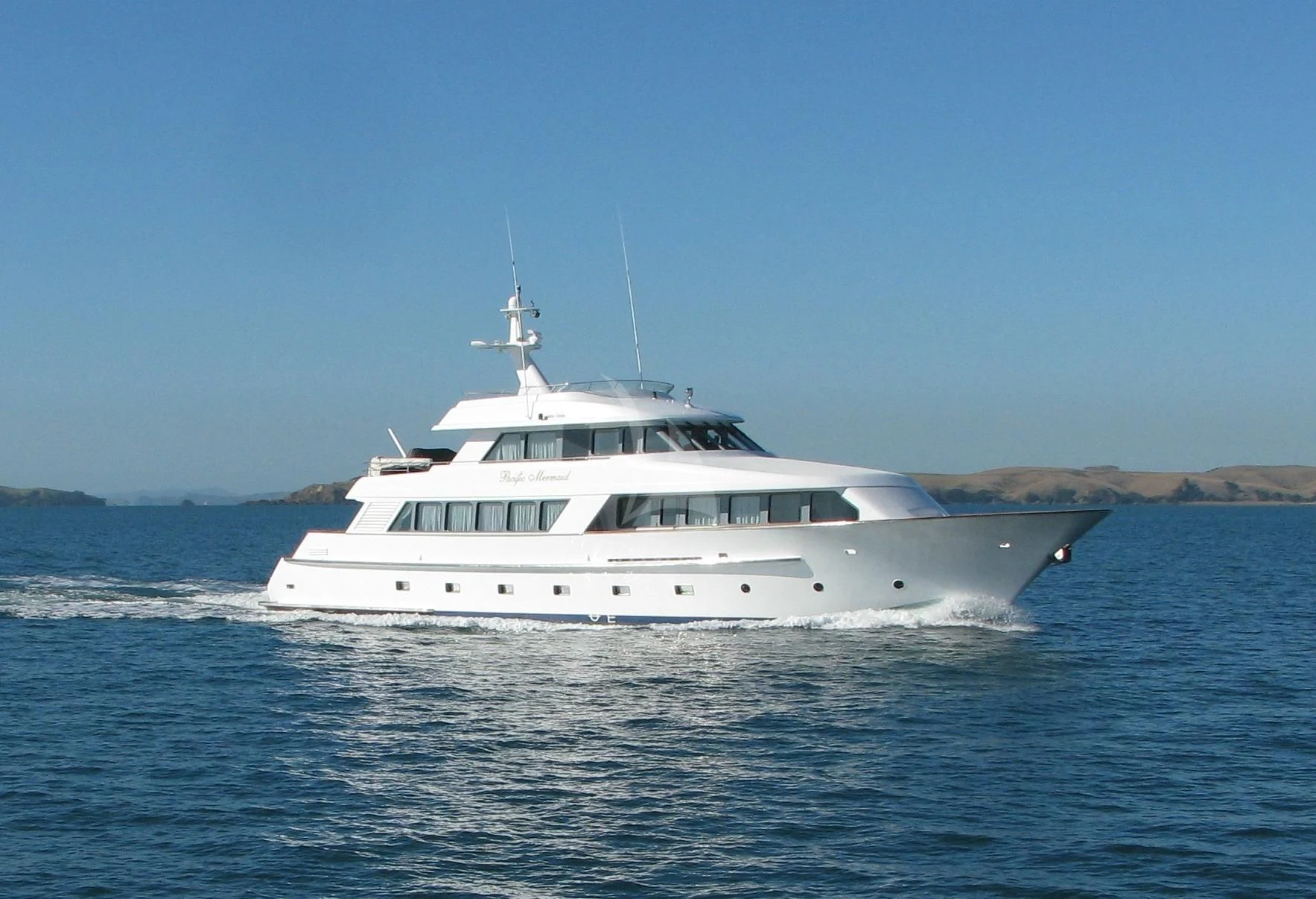 a white boat in the water aboard PACIFIC MERMAID Yacht for Sale