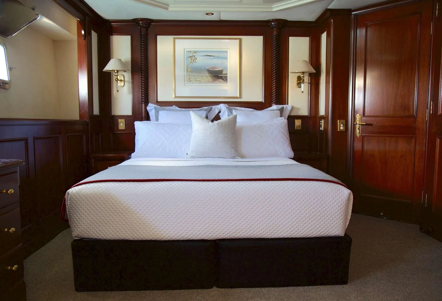 a bed with white sheets aboard PACIFIC MERMAID Yacht for Sale