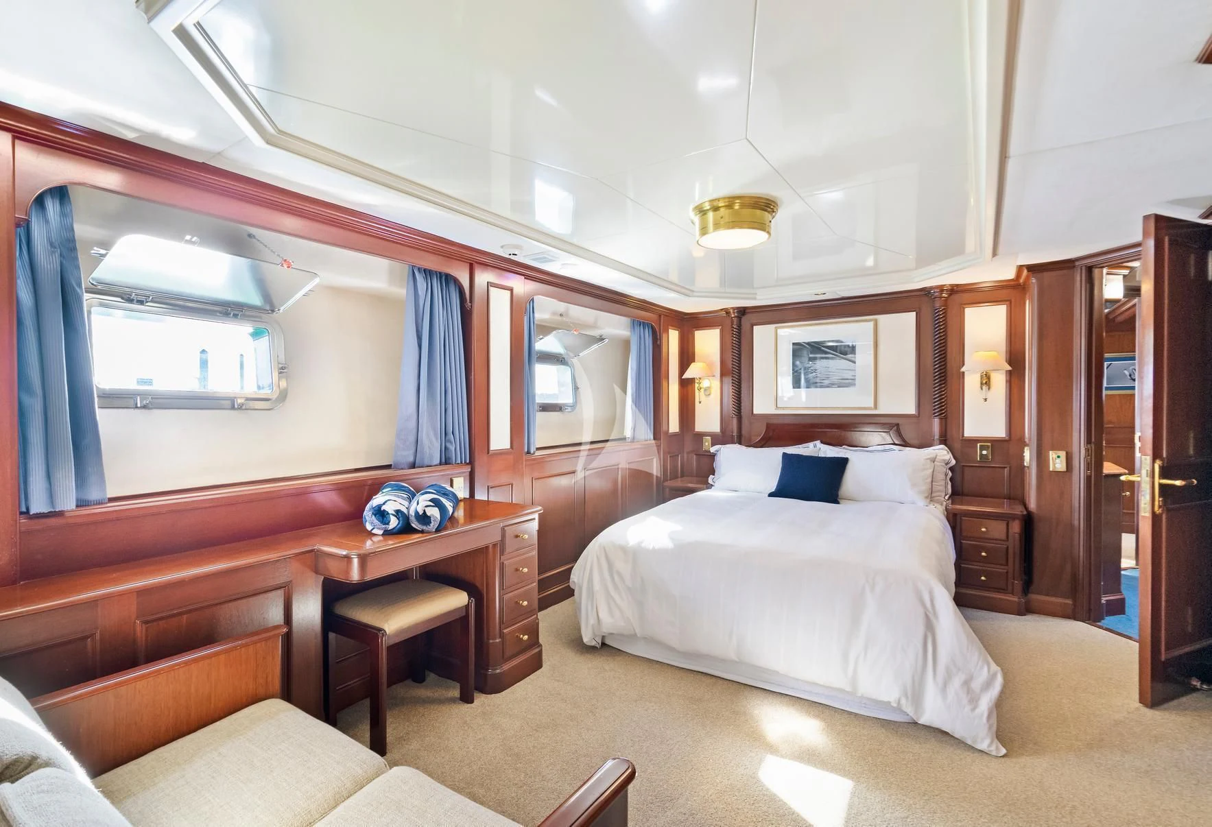 a bedroom with a bed and a desk aboard PACIFIC MERMAID Yacht for Sale
