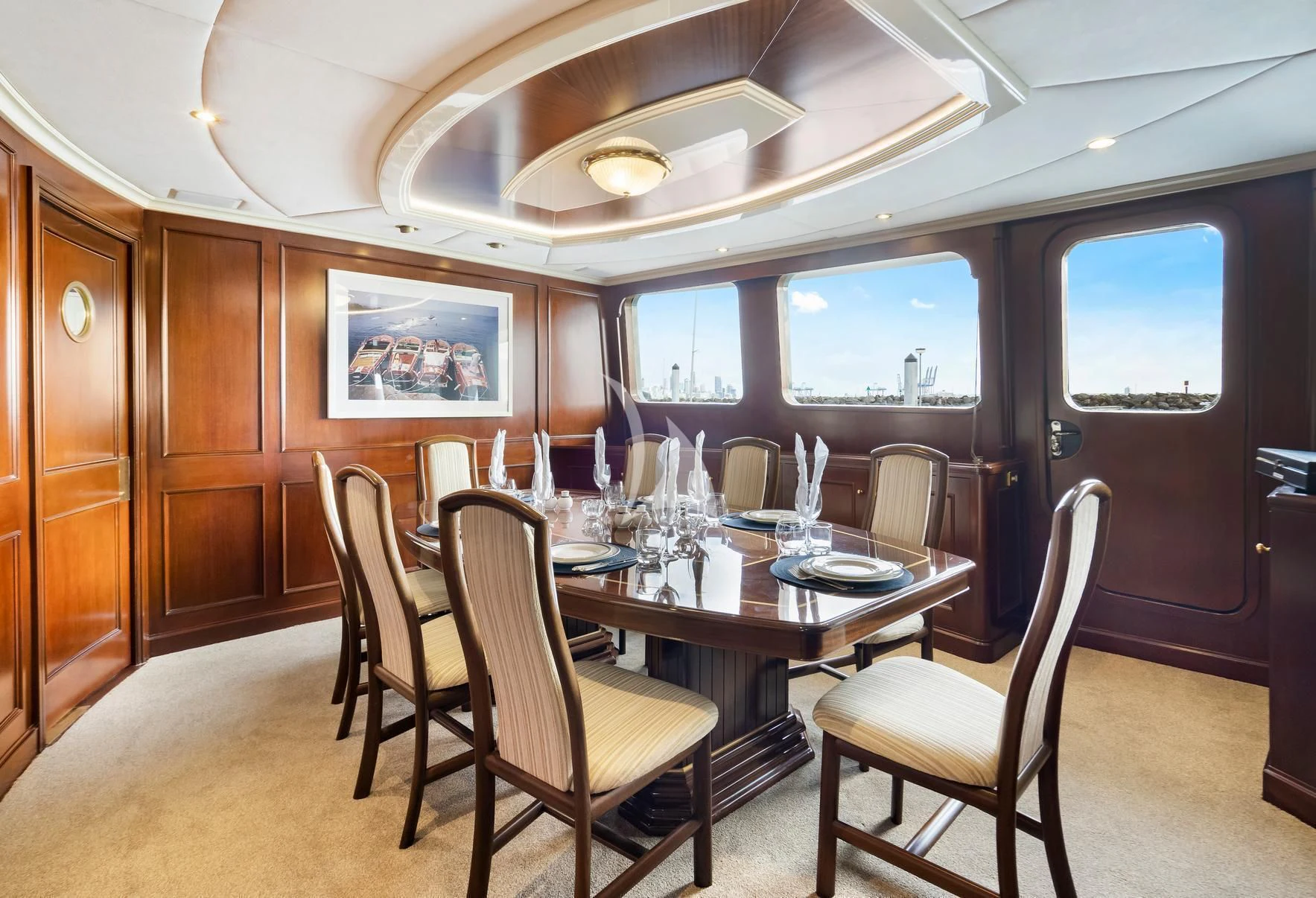 a dining room with a table and chairs aboard PACIFIC MERMAID Yacht for Sale