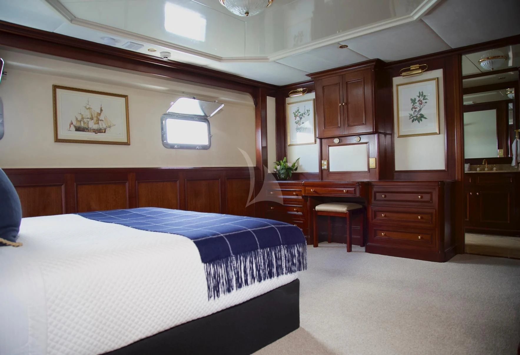 a bedroom with a bed and cabinets aboard PACIFIC MERMAID Yacht for Sale