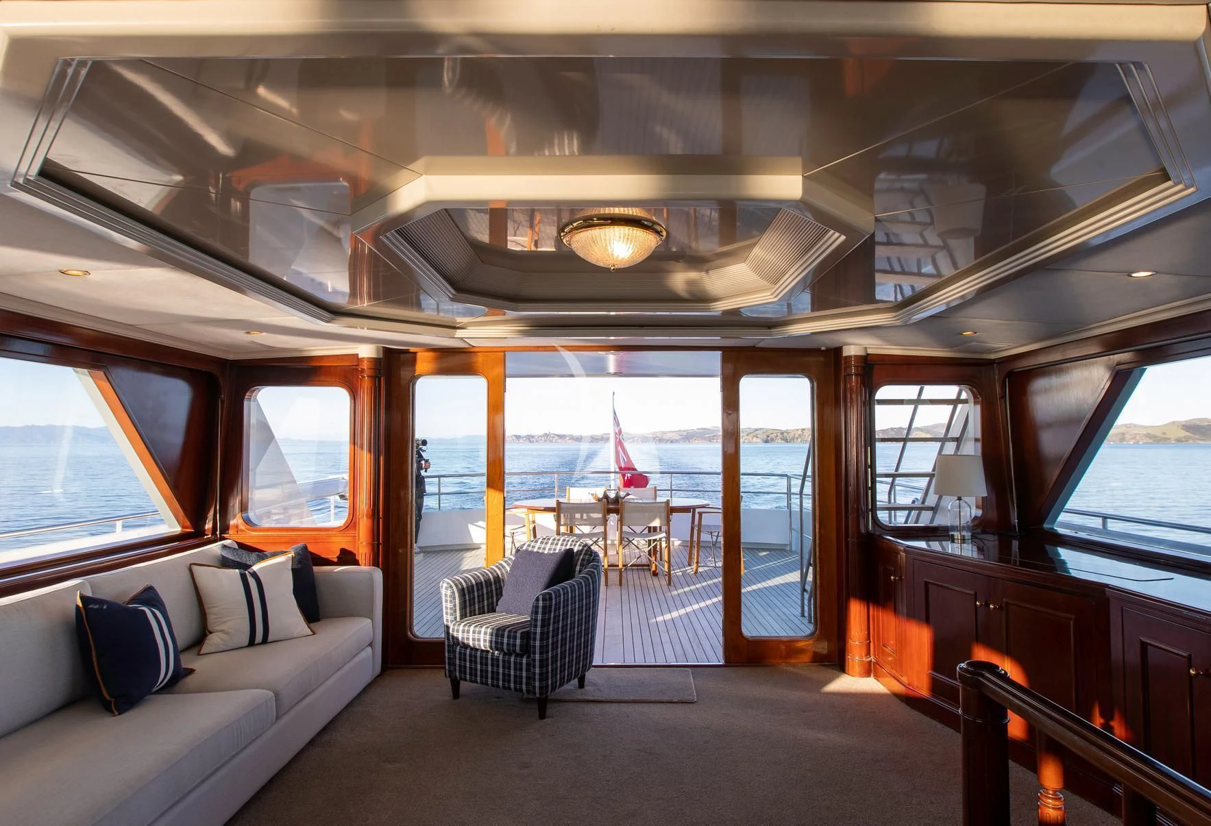 a train car with a view of the water and the deck aboard PACIFIC MERMAID Yacht for Sale