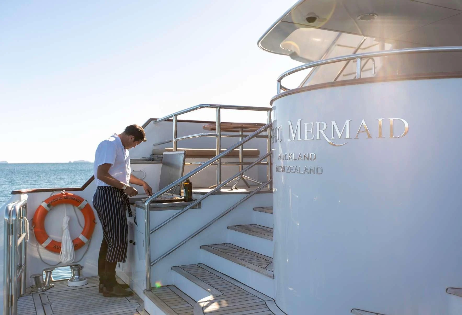 a man standing on a boat aboard PACIFIC MERMAID Yacht for Sale