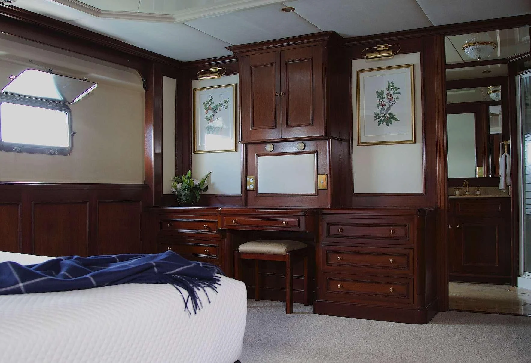a bedroom with a desk and a bed aboard PACIFIC MERMAID Yacht for Sale