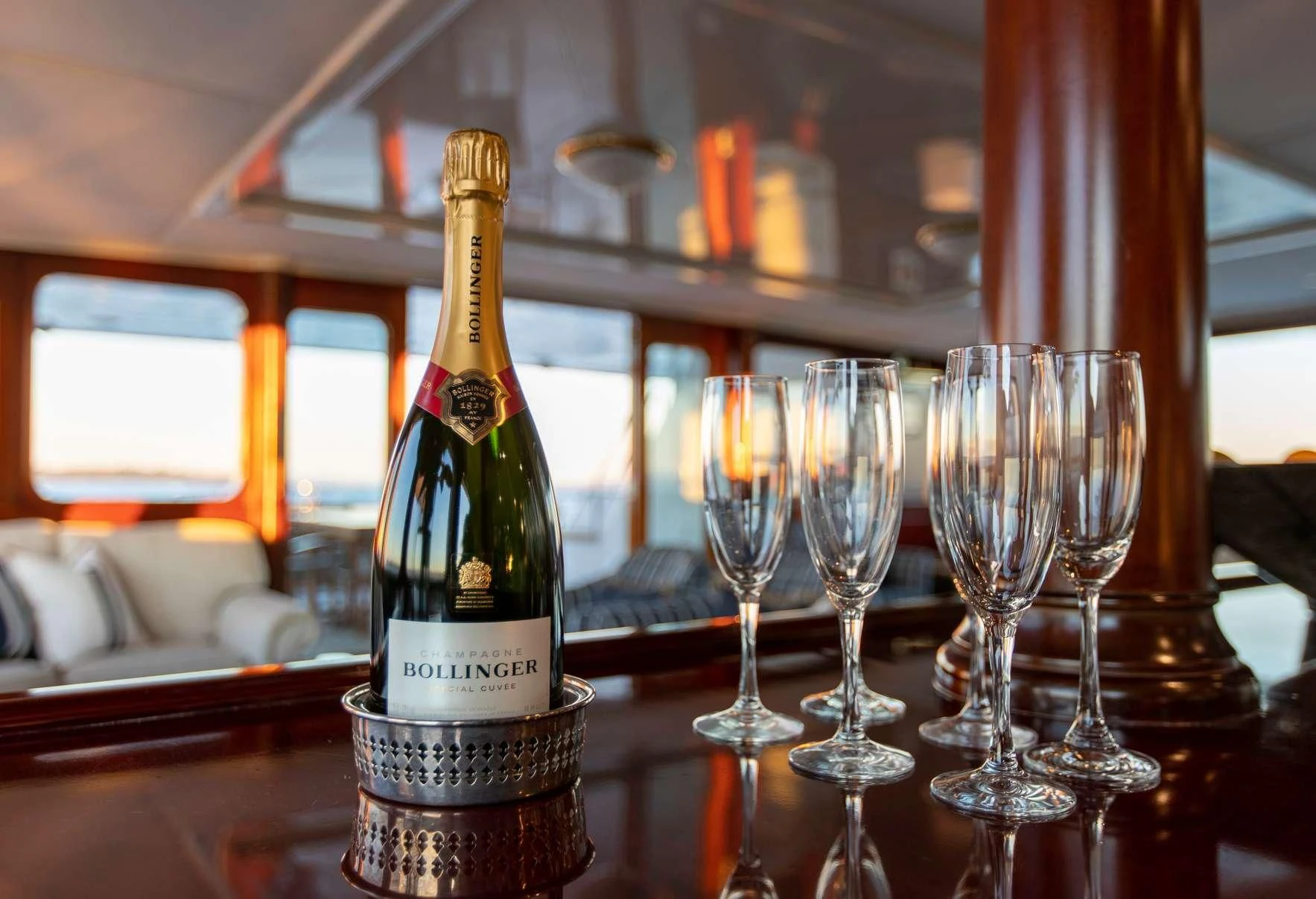 a bottle of wine and a glass aboard PACIFIC MERMAID Yacht for Sale