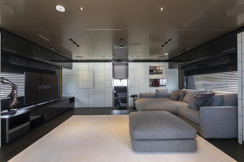 a living room with a couch and a fireplace aboard RUSH Yacht for Sale