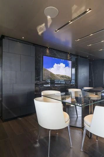 a room with a table and chairs aboard RUSH Yacht for Sale