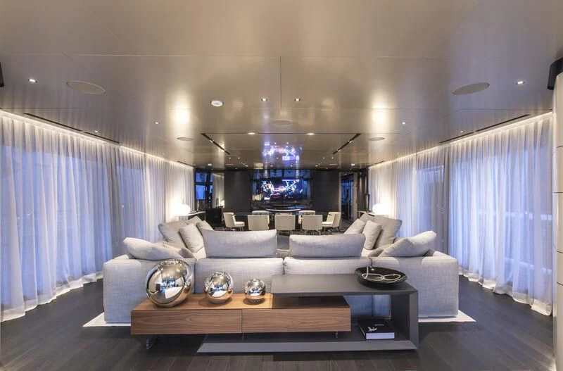 a living room with a large blue curtain aboard RUSH Yacht for Sale