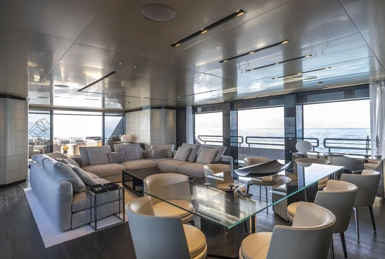 a room with a table chairs and a large window aboard RUSH Yacht for Sale