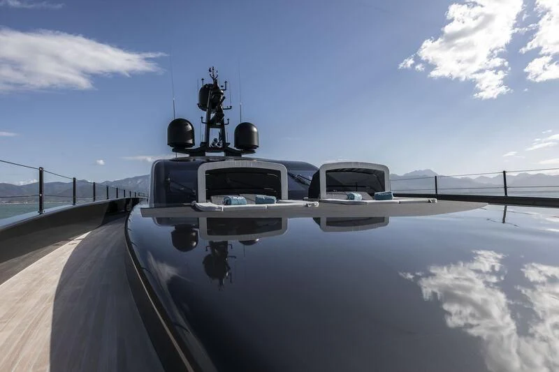 a large military vehicle driving on a road aboard RUSH Yacht for Sale