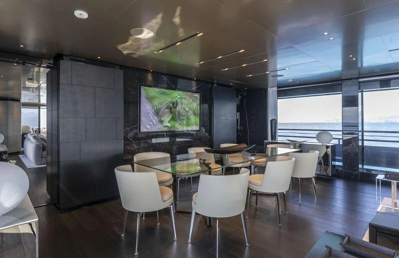 a room with a table and chairs aboard RUSH Yacht for Sale