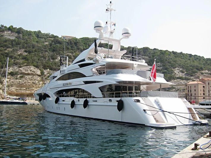 a large white boat in a harbor aboard WILD ORCHID I Yacht for Sale