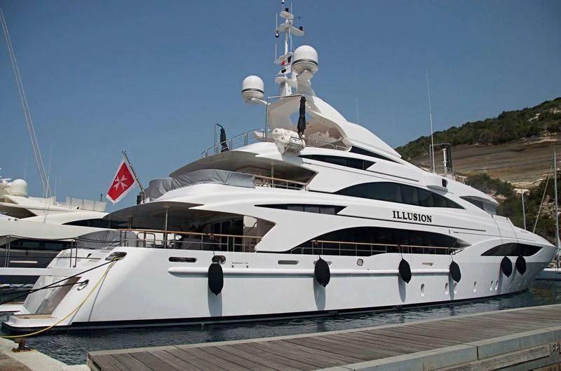 a white yacht on a dock aboard WILD ORCHID I Yacht for Sale