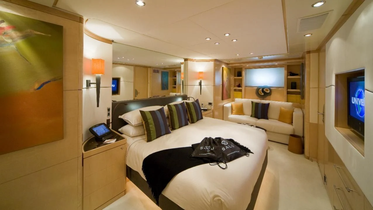 a room with a bed and a television aboard SALUTE Yacht for Sale