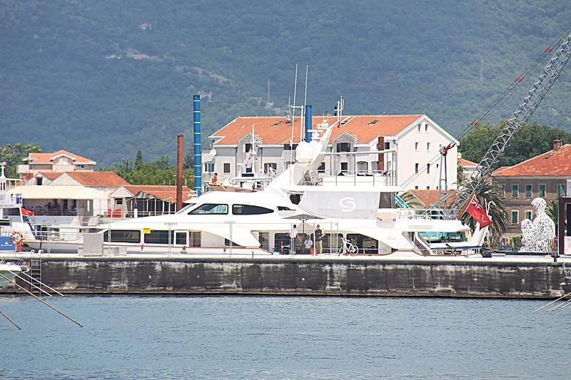 a white boat on a dock aboard SALUTE Yacht for Sale