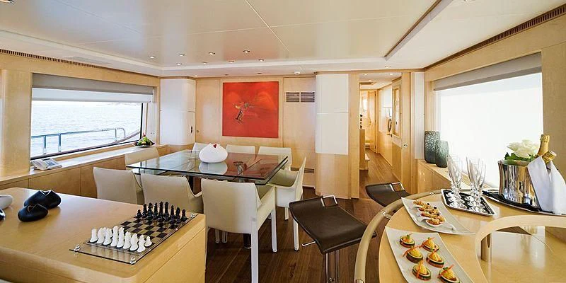 a room with a table and chairs aboard SALUTE Yacht for Sale
