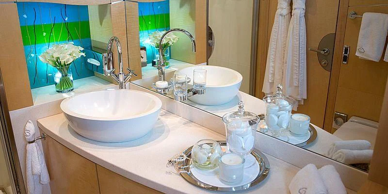 a bathroom with a sink and a mirror aboard SALUTE Yacht for Sale