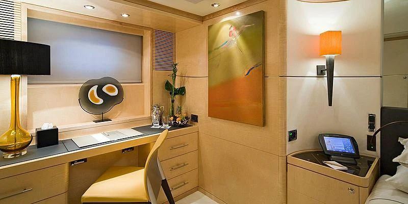 a room with a desk and a lamp aboard SALUTE Yacht for Sale