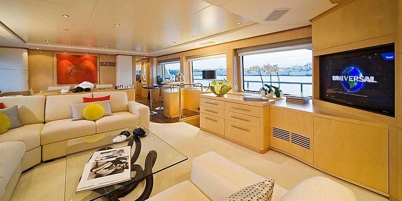 a living room with a large screen aboard SALUTE Yacht for Sale