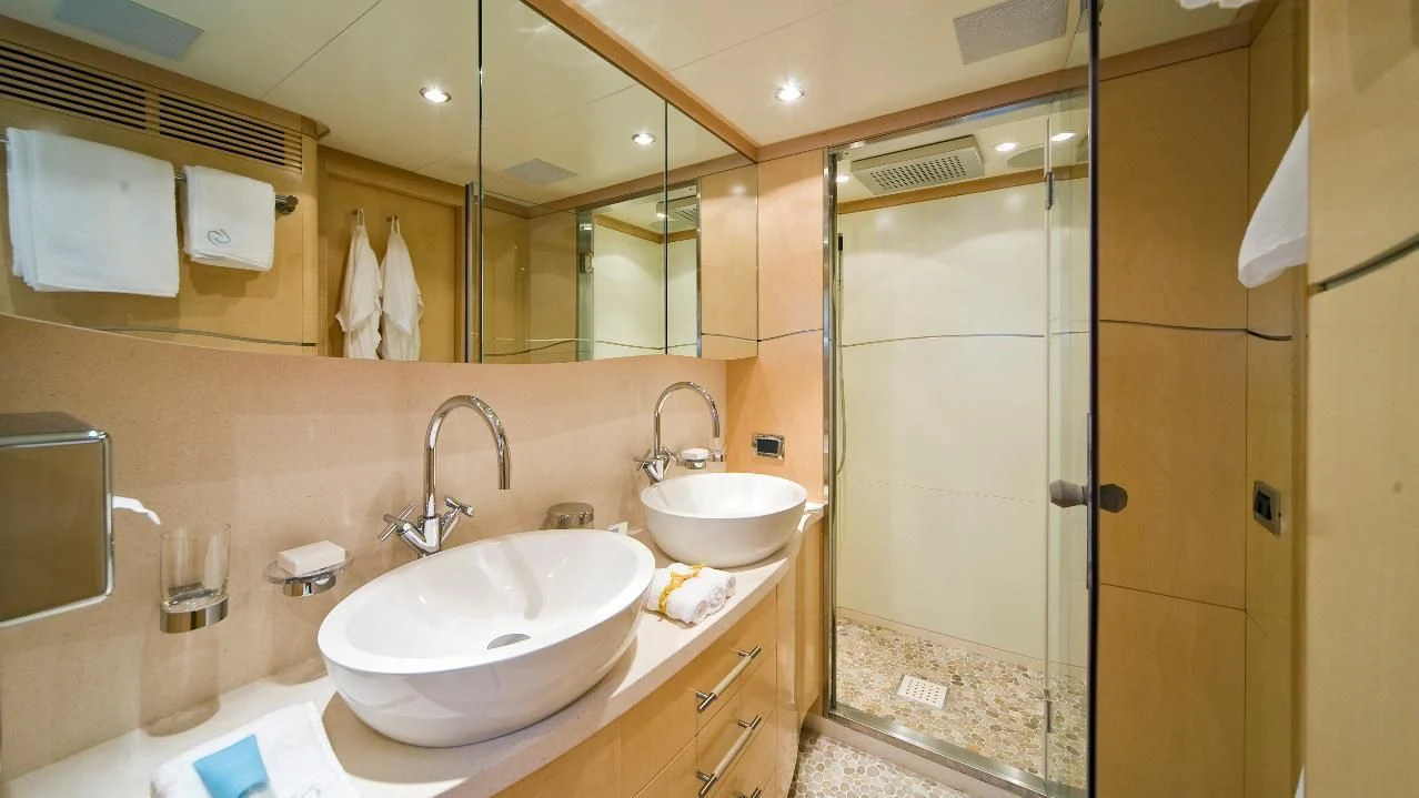 a bathroom with two sinks aboard SALUTE Yacht for Sale
