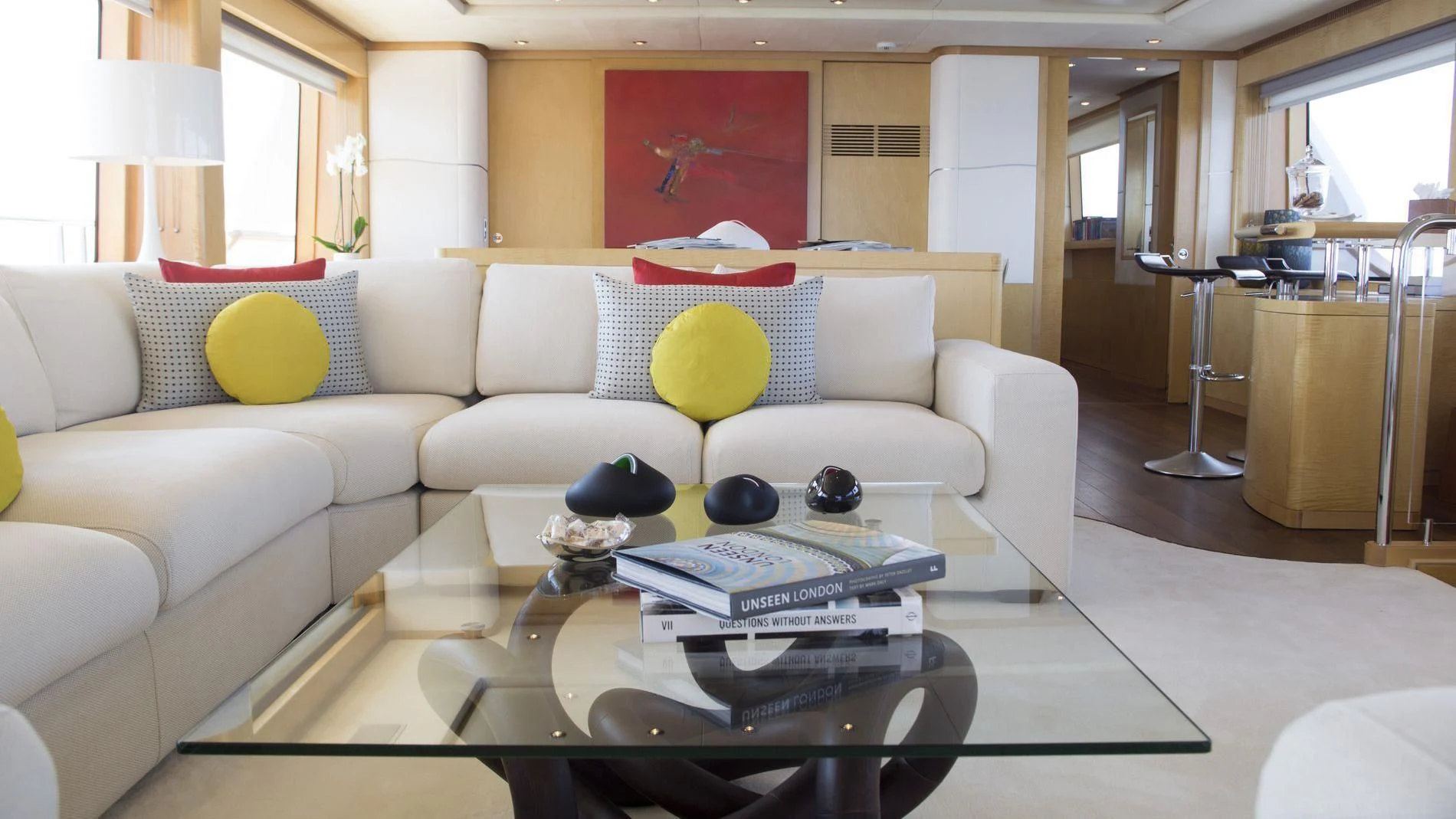 a living room with a white couch and a coffee table aboard SALUTE Yacht for Sale
