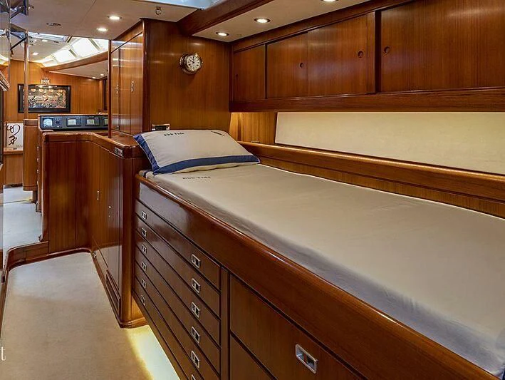 a room with a bed and a desk aboard EBB TIDE Yacht for Sale