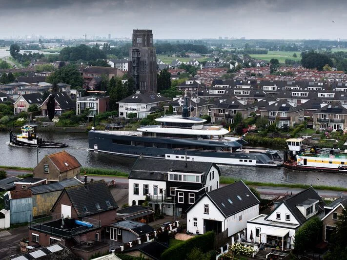 a city with many buildings and a tower in the distance aboard B Yacht for Sale