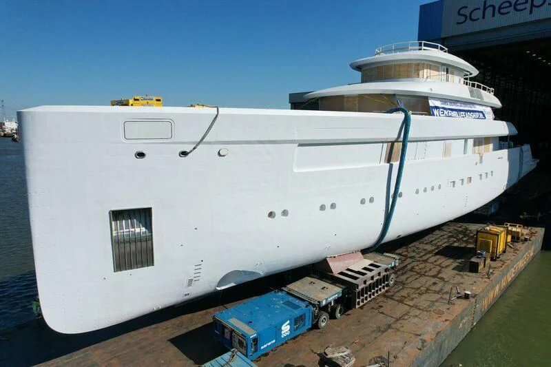 a large white ship docked aboard B Yacht for Sale
