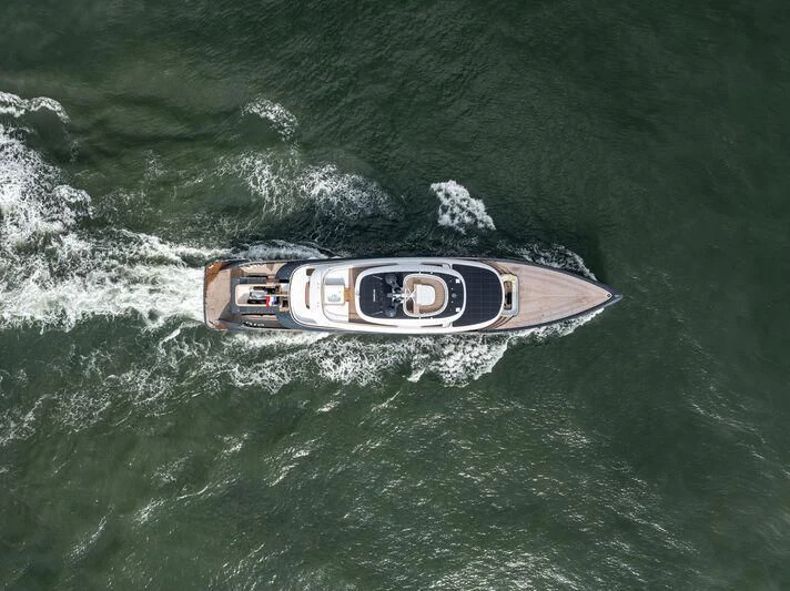 a speed boat in the ocean aboard B Yacht for Sale