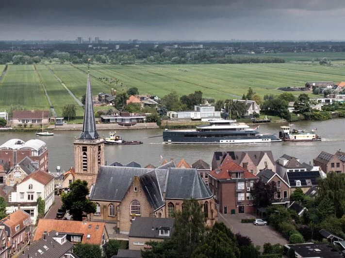 a river with boats and buildings aboard B Yacht for Sale
